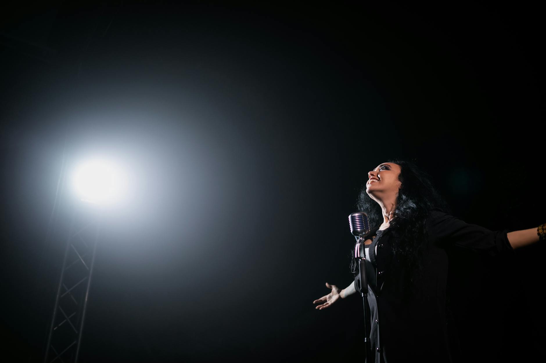 Singer performing on stage with a microphone
